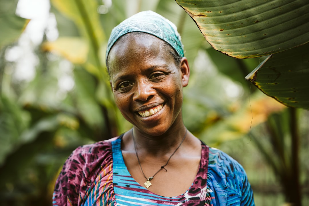 a-woman-standing-in-front-of-a-banana-tree-qe0x1yzwbu